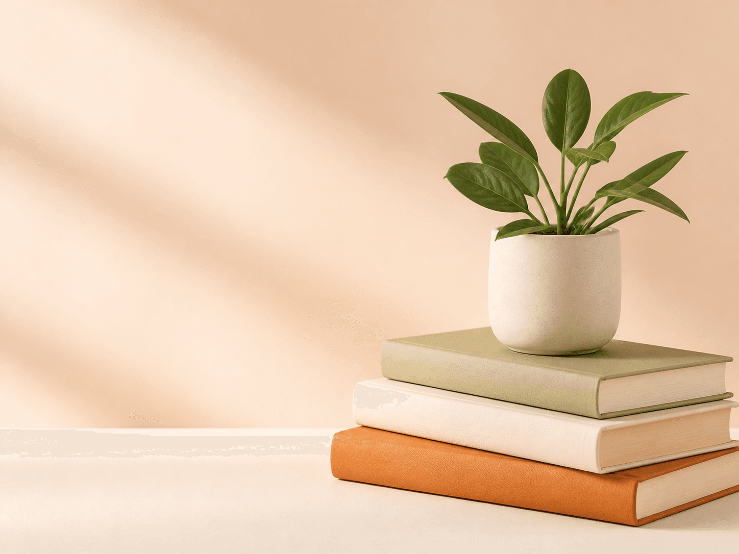 Health and wellness books with a green plant