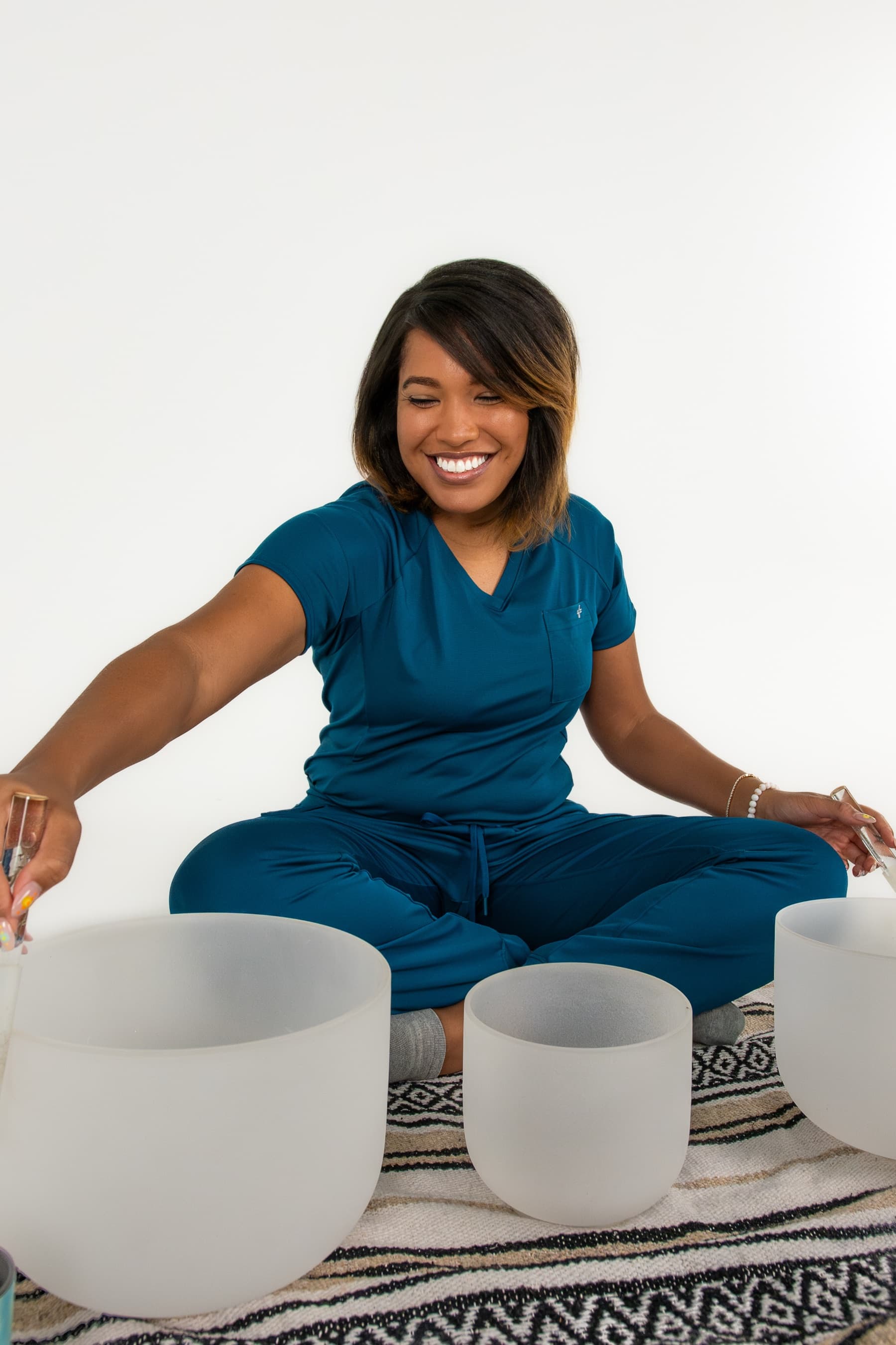 Black holistic wellness practitioner with singing bowls